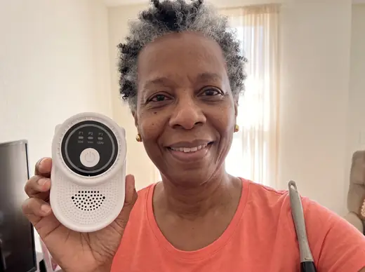 Denise taking a selfie with Ion Pure Pro and a feather duster